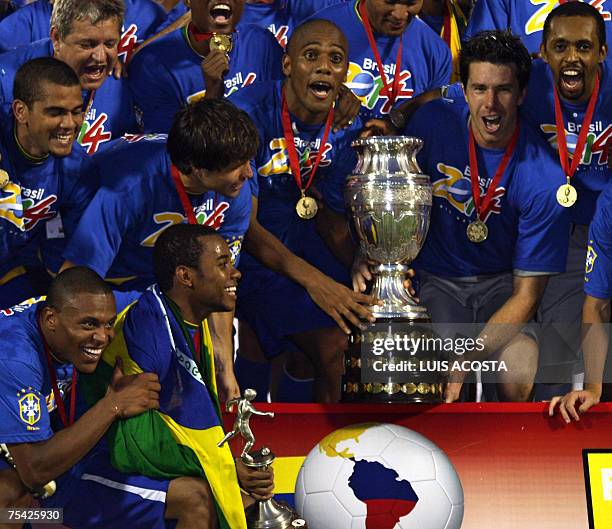 BrazilIAN players celebrate with the trophy after they won the Copa America 2007 final match against Argentina at the Pachencho Romero stadium in...
