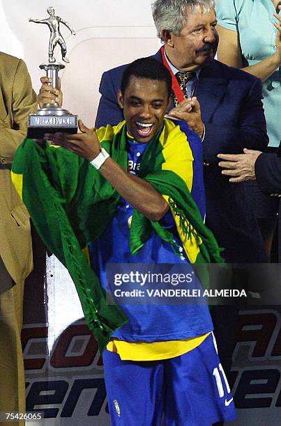 Brazilian player Robinho holds the striker tournament trophy he was awarded after Brazil won the Copa America 2007 final match against Argentina at...