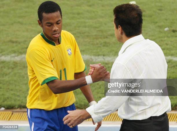 Brazilian player Robinho is congratulated by his coach Dunga during the Copa America Venezuela-2007 final match against Argentina, 15 July, 2007 at...