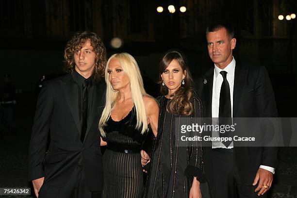 Donatella Versace poses with her son Daniel , daughter Allegra and Paul Back as they arrive at the dinner at Palazzo Reale, after the ballet "Thanks...
