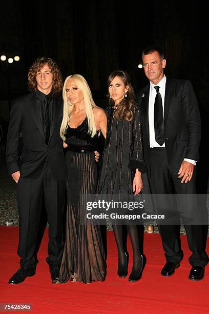 Donatella Versace poses with her son Daniel , daughter Allegra and Paul Back as they arrive at the dinner at Palazzo Reale, after the ballet "Thanks...