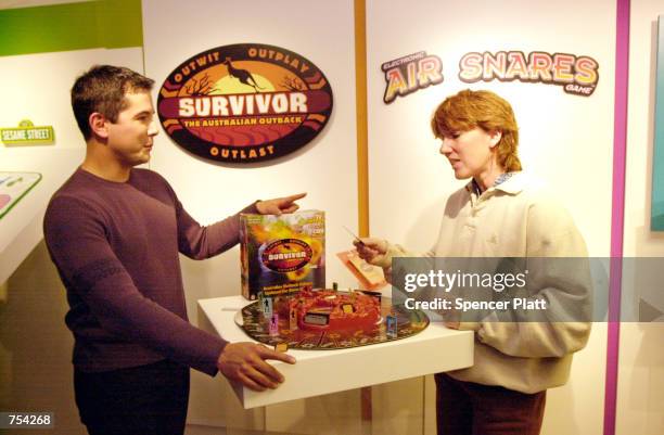 Kel Gleason, left, and Deb Eaton, ex-contestants on the television show "Survivor," promote the new Survivor game February 9, 2001 at the American...