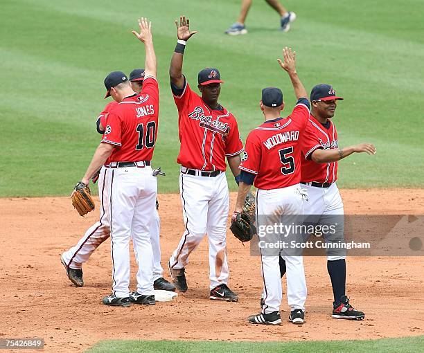 Chipper Jones and Chris Woodward of the Atlanta Braves celebrate after the game against the Pittsburgh Pirates at Turner Field July 15, 2007 in...