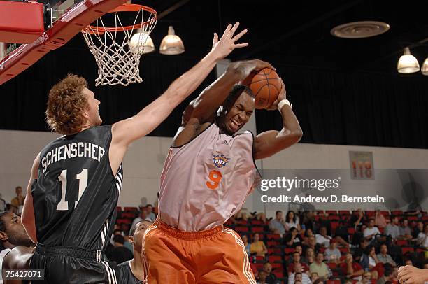 Otis George of the Phoenix Suns grabs a rebound against Luke Schenscher of the Minnesota Timberwolves during the NBA Summer League on July 15, 2007...