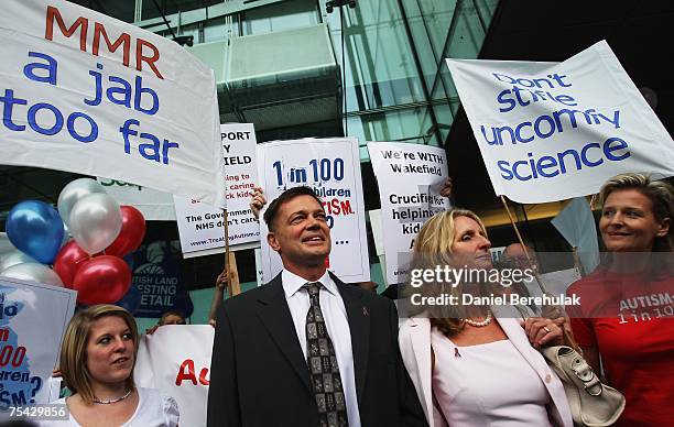 Gastroenterologist Dr Andrew Wakefield arrives with wife Carmel flanked by supporters on July 16, 2007 on London, England. Wakefield is appearing...