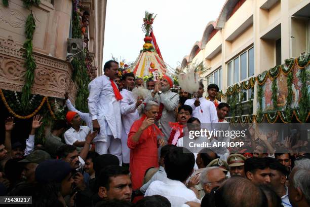 Chief Minister of the Indian state of Gujarat Narendra Modi gestures as he stands with devotees atop Lord Jaggannath Rath at The Jaggannathji Mandir...