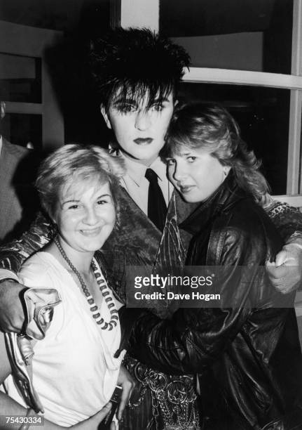 British singer Steve Strange of new romantic pop group Visage, with two female fans, 1984.