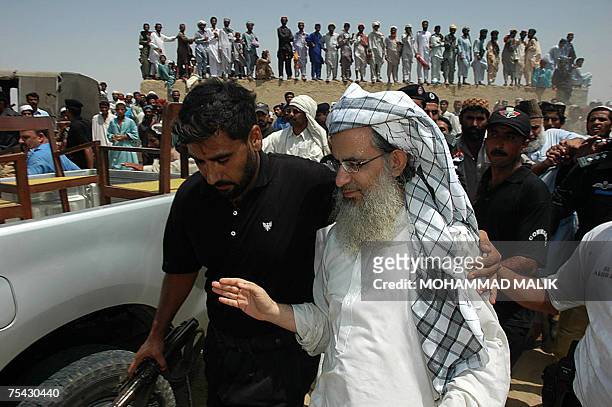 Basti Abdullah, PAKISTAN: Pakistani policemen escort Abdul Aziz , chief cleric of The Red Mosque, as he arrives in the village of Basti Abdullah, 12...