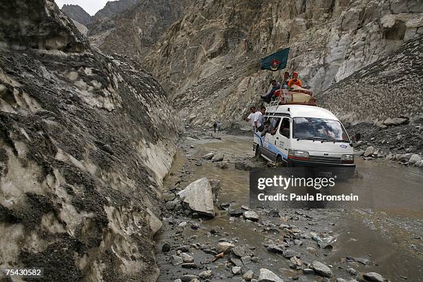 Car drives through a melting glacier on the Karakoram highway on July 6, 2007 in the Upper Hunza Region, Northwest Frontier Province, Pakistan. This...