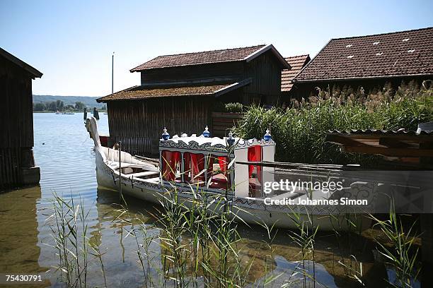 Fairy tale boat is seen between boathouses at the Ammersee Lake on July 16, 2007 in Diessen am Ammersee, Germany. The heatwave is expected to...