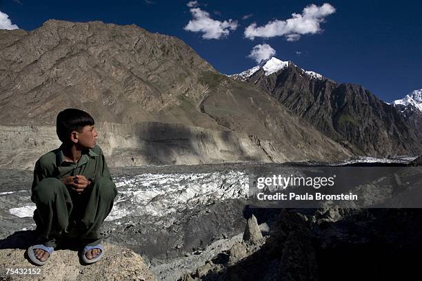 Boy looks at the Hopar glacier on July 6, 2007 in the Nagar district of Gilgit-Baltistan in Pakistan-administered Kashmir. This year is on track to...