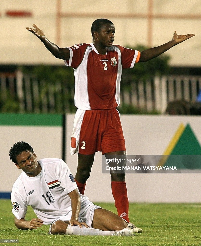 Maham Rabia Oman's Mohamed Rabia gestures as Iraq's Mahdi Karim grimaces in pain ...