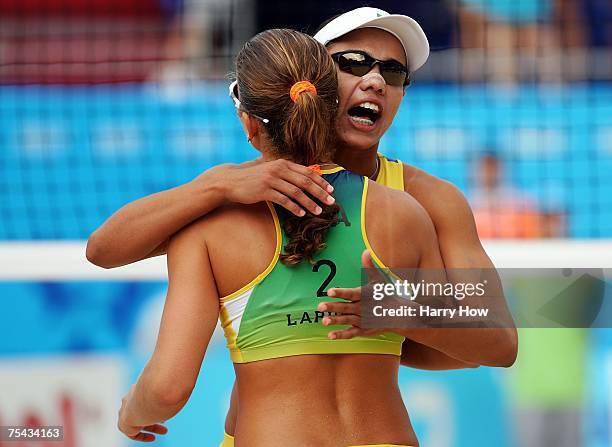 Juliana Silva of Brazil celebrates a point with teammate Larissa Franca of Brazil during their match against Angie Akers and Brooke Niles Hanson of...