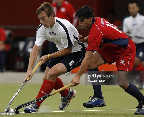 Rio de Janeiro, BRAZIL: Jarred Martin of the US vies for the ball with Matias Amoroso of Chile during their field hockey match at the XV Pan American...