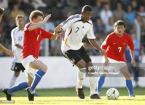 July 16: Jerome Boateng of Germany and Pavel Mamaev of Russia fight for the ball during the UEFA U19 European Championship between Germany and Russia...