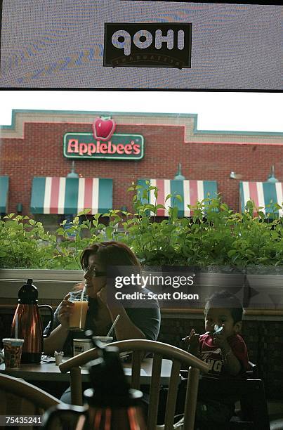 Customers sit in an IHOP restarant located across a parking lot from an Applebee's restaurant July 16, 2007 in Elgin, Illinois. IHOP Corp. Has agreed...