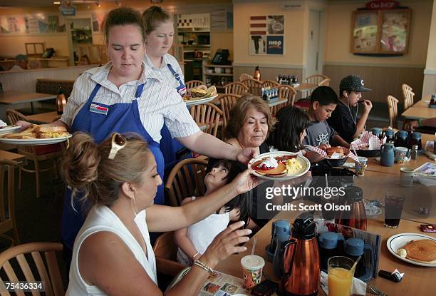 Waitresses Gretchen Boren and Michelle Enright wait on customers at an IHOP restaurant July 16, 2007 in Elgin, Illinois. IHOP Corp. Has agreed to...