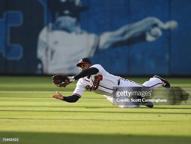 Andruw Jones of the Atlanta Braves makes a diving catch against the Cincinnati Reds at Turner Field July 16, 2007 in Atlanta, Georgia. The Reds...