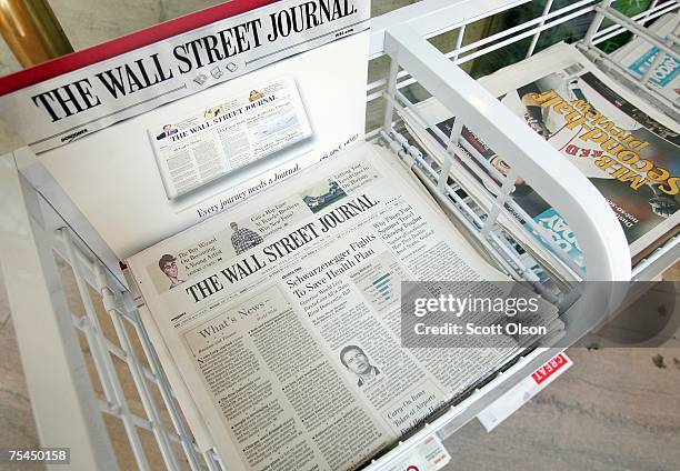 The Wall Street Journal newspaper is offered for sale alongside other papers at a newsstand in the Chicago Board of Trade building July 17, 2007 in...