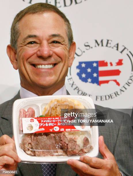 Japanese professional baseball team Lotte Marines manager Bobby Valentine smiles as he introduces a special lunch box using US beef and pork during a...