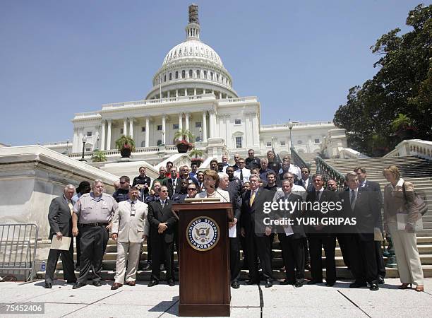 Washington, UNITED STATES: US House Speaker Nancy Pelosi accompanied by police and firefighters representatives speaks during a news conference in...