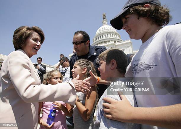 Washington, UNITED STATES: US House Speaker Nancy Pelosi greets family of firefighter Ronald Kuley from Virginia after a news conference in front of...