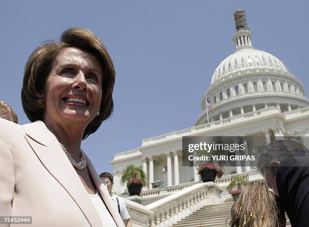Washington, UNITED STATES: US House Speaker Nancy Pelosi smiles in front of the US Capitol in Washington 17 July 2007 after a news conference to...