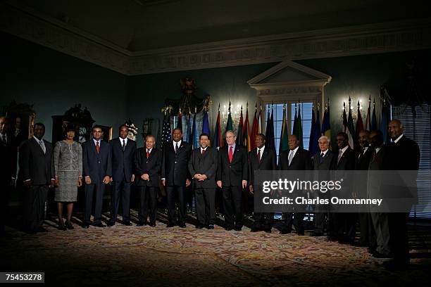 President George W. Bush poses for photographs with Caribbean leaders during the Conference on the Caribbean at the State Department on June 20, 2007...