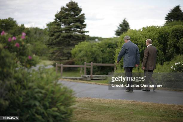 President George W. Bush talks with Russian President Vladamir Putin as they tour the grounds at the Bush family house at Walker's Point on July 01,...