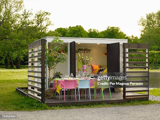 a table set for party in a garden sweden. - modern garden shed stockfoto's en -beelden