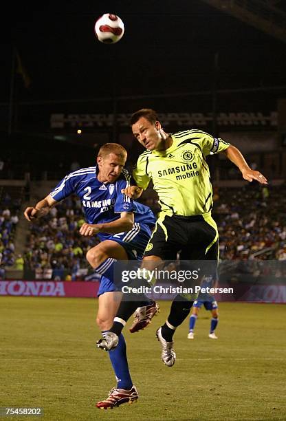 Soon Hak Hong of the Suwon Samsung Bluewings and John Terry of Chelsea FC jump for a header during the World Series of Football match at the Home...