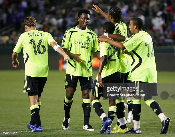 John Mikel Obi of Chelsea FC congratulates Didier Drogba after he scored against the Suwon Samsung Bluewings during the World Series of Football...