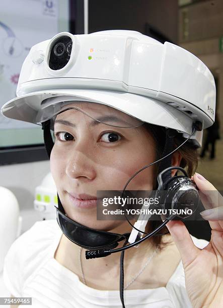 Japan's safety goods maker Tanizawa employee displays a prototype model of the mobile utility helmet "U-met", equipped with a QVGA mobile camera, GPS...