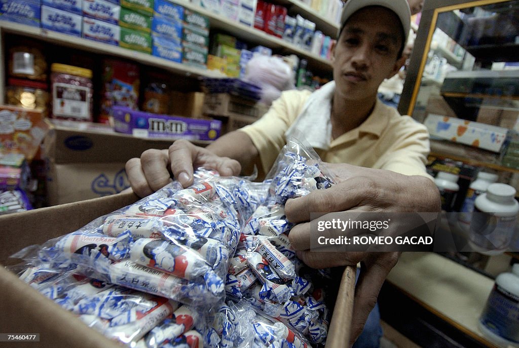 A store personnel shows a box of the pop...