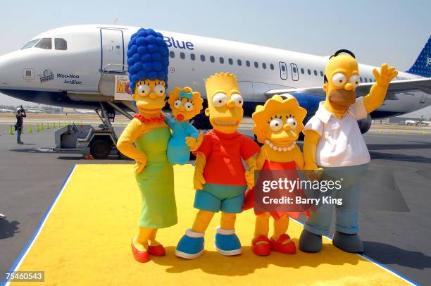 The Simpsons family members Marge, Maggie, Bart, Lisa and Homer Simpson attending the JetBlue Airways Unveiling of "Simpsons" aircraft to celebrate...