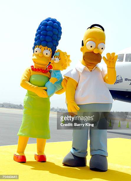 The Simpsons family members Marge, Maggie and Homer Simpson at the JetBlue Airways Unveiling of "Simpsons" aircraft to celebrate upcoming release of...