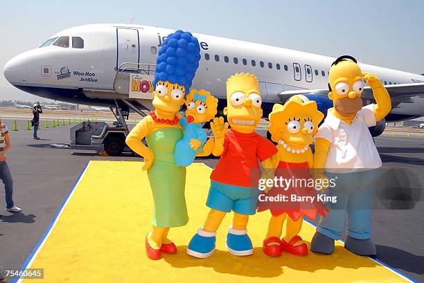 The Simpsons family members Marge, Maggie, Bart, Lisa and Homer Simpson attending the JetBlue Airways Unveiling of "Simpsons" aircraft to celebrate...