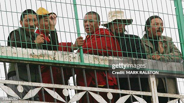 Group of Tibetan's watch the arrival of the first train from Beijing to the Tibetan capital Lhasa, from a railway bridge in the city of Xining, 02...