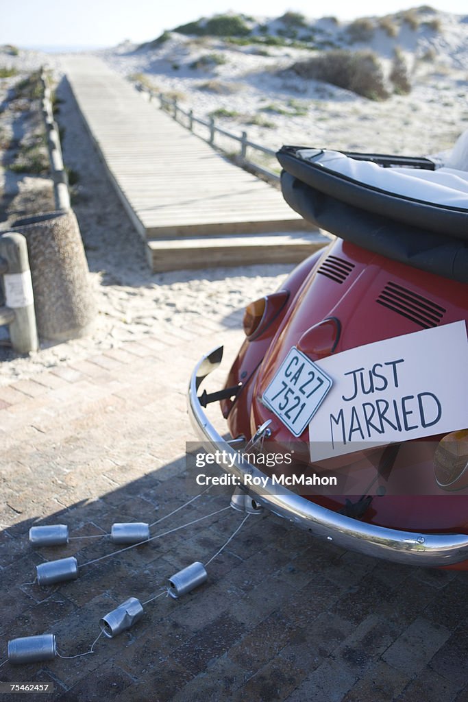 Just married sign on car on beach