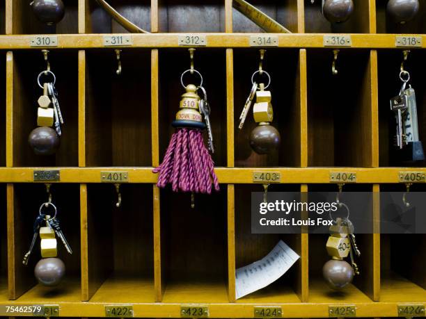 hotel room keys in pigeon holes, close-up - hotel key stock-fotos und bilder