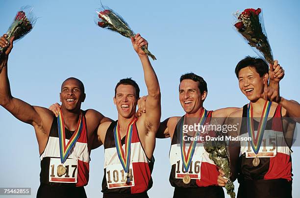 track relay team wearing medals celebrating victory. california, usa. - sportsperson medal stock pictures, royalty-free photos & images