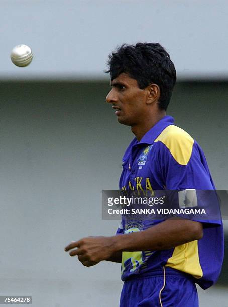 Sri Lankan Cricket Invitational XI cricketer Upul Chandana spins the ball as he prepares to bowl during a practice match against Bangladesh at The...