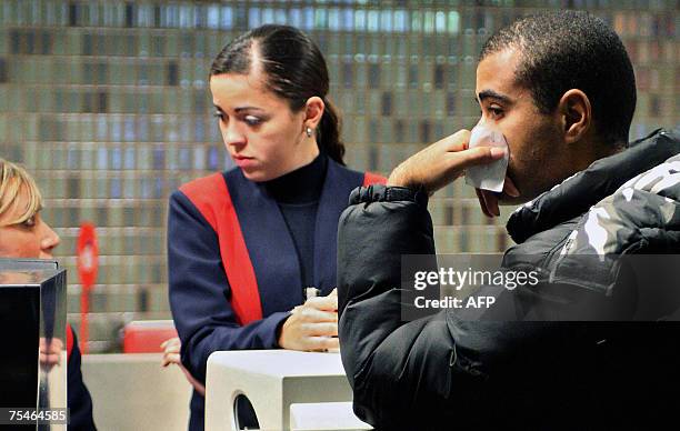 Relative of a victim of the Tam Airlines Airbus 320 that crashed into Sao Paulo's airport yesterday, waits for news of his beloved one at Porto...