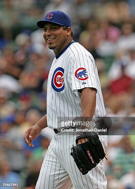 Starting pitcher Carlos Zambrano of the Chicago Cubs smiles at teammate Mark DeRosa in the first inning against the San Francisco Giants on July 18,...