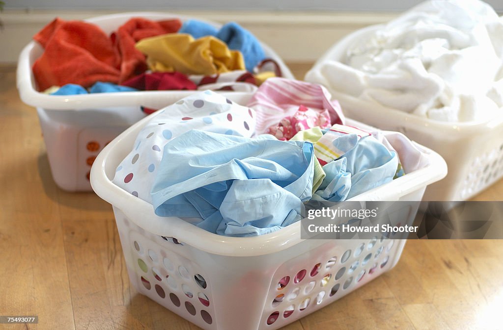 Clean washing in three plastic laundry baskets