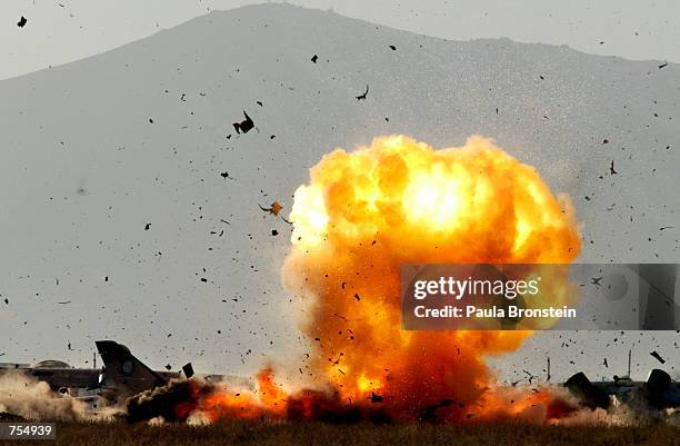 An SU-21 Russian Fitter aircraft is blown up with explosives by the British Royal Air Force Bomb disposal squadron February 11, 2002 at Kabul...