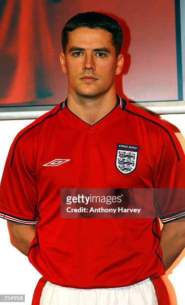 England soccer player Michael Owen models the new England away strip--a red short-sleeved shirt, white shorts and red socks--February 11, 2002 at its...