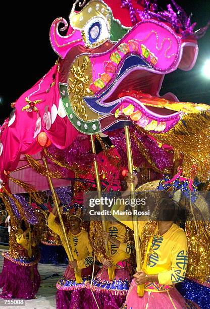 Members of the School of Samba Unidos da Tijuca participate in a Carnival parade with a dragon February 11, 2002 in Rio de Janeiro, Brazil.