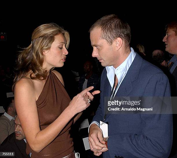 Model Frederique Van Der Wal talks with Giuseppe Cipriani at the Luca Luca Fashion Show February 12, 2002 in New York City.