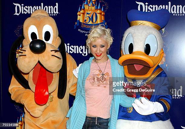 Christina Aguilera with Pluto and Donald Duck at the Disneyland in Anaheim, California